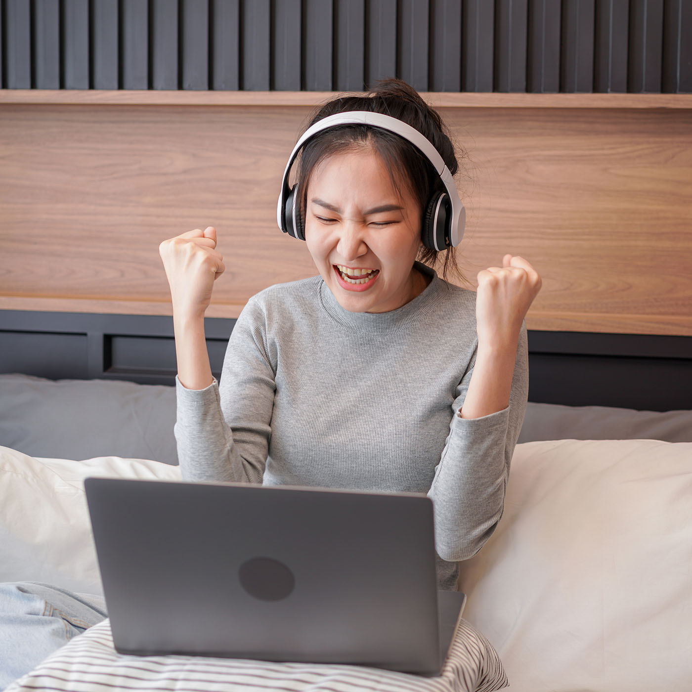 asian woman with headphone raising hands after rec 2022 11 15 15 36 13 utc